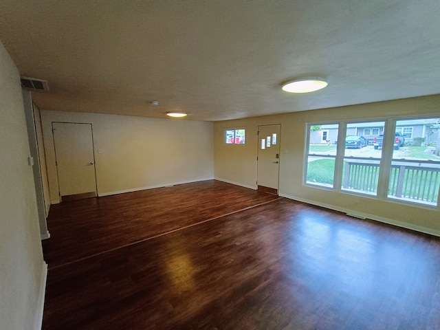 unfurnished room featuring dark hardwood / wood-style floors