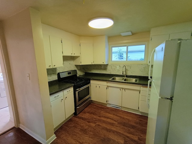 kitchen featuring tasteful backsplash, white cabinets, gas stove, sink, and white fridge