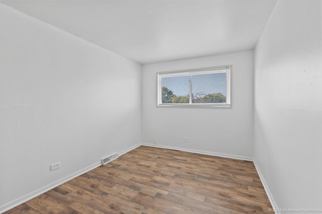 spare room with dark hardwood / wood-style floors