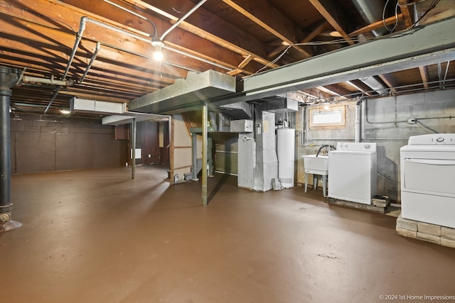 basement featuring gas water heater, independent washer and dryer, and sink