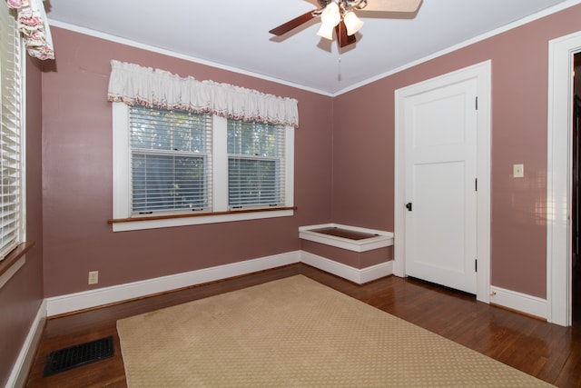 spare room with dark hardwood / wood-style floors, crown molding, and ceiling fan