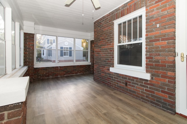 unfurnished sunroom with ceiling fan