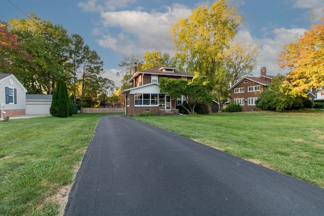 view of front facade with a front yard and a garage