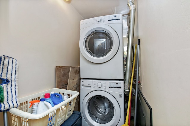 clothes washing area with stacked washer and clothes dryer