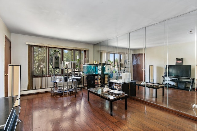 living room with baseboard heating and dark wood-type flooring