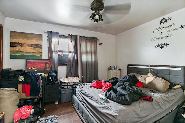 bedroom with ceiling fan and dark hardwood / wood-style flooring