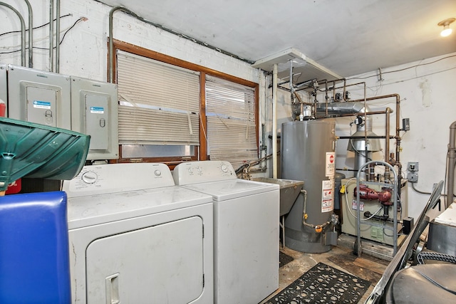 clothes washing area with gas water heater and washing machine and clothes dryer