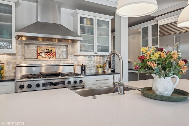 kitchen featuring wall chimney exhaust hood, sink, decorative backsplash, and white cabinets