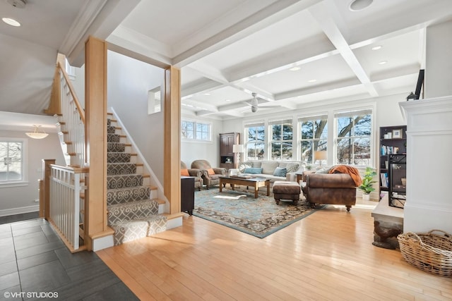 living room featuring coffered ceiling, beam ceiling, wood-type flooring, and ceiling fan