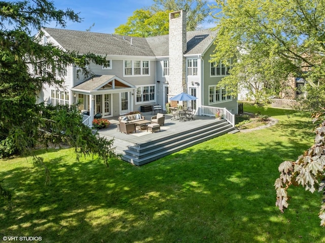 rear view of property featuring an outdoor living space, a yard, and a deck