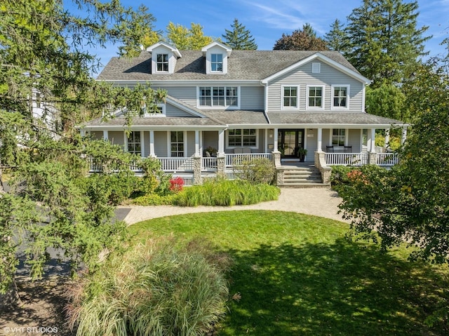 view of front of property with covered porch and a front lawn