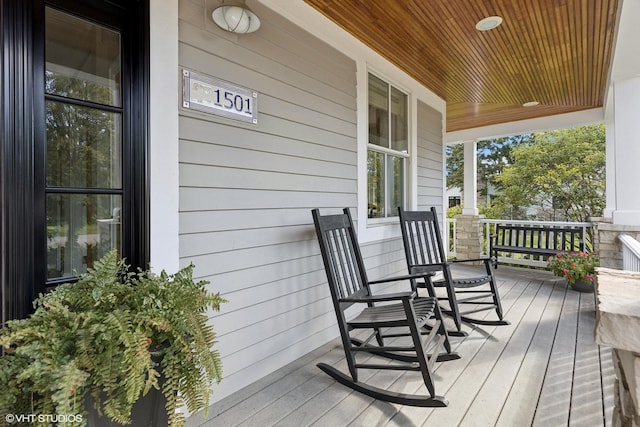 wooden terrace with a porch