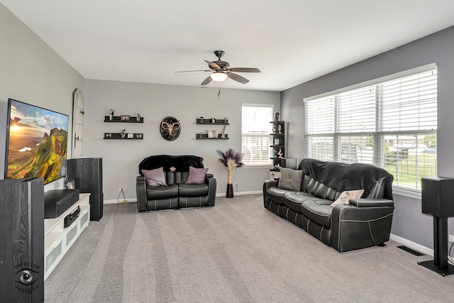 carpeted living room with ceiling fan