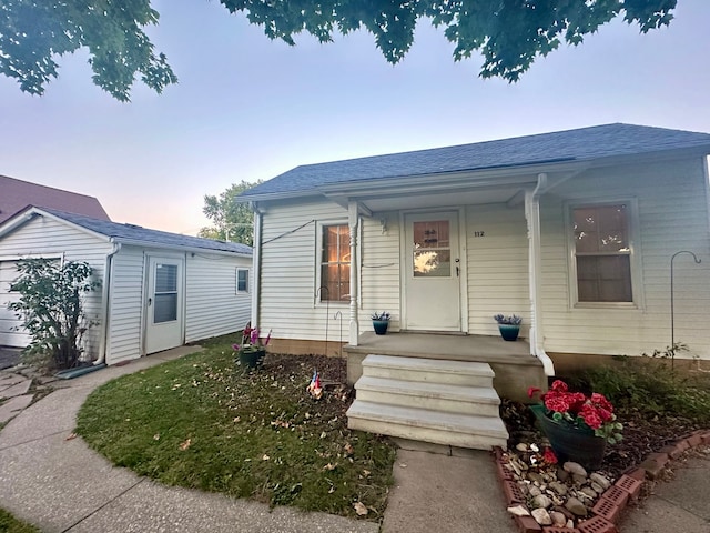 view of front facade featuring a porch and a garage