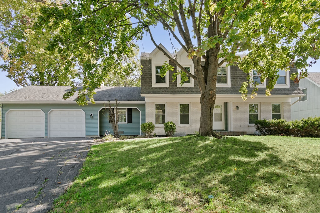 view of front of property with a front lawn and a garage