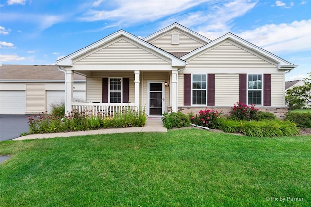 view of front of home with a front yard, a garage, and a porch