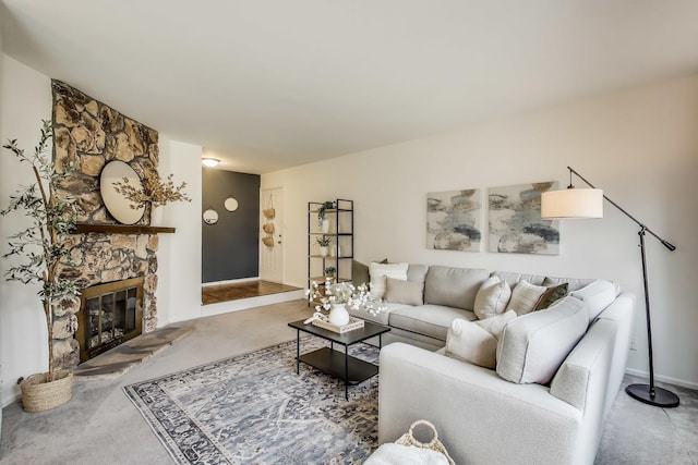 living room featuring a fireplace, baseboards, and carpet