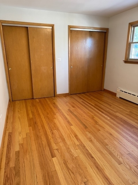 unfurnished bedroom with light wood-type flooring