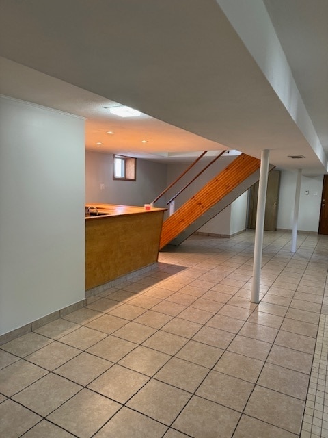 additional living space featuring light tile patterned floors