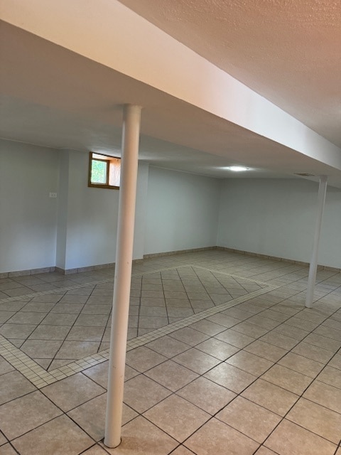 basement featuring light tile patterned floors