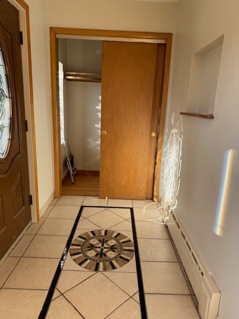 tiled entrance foyer featuring baseboard heating