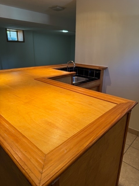 kitchen featuring sink and light tile patterned floors