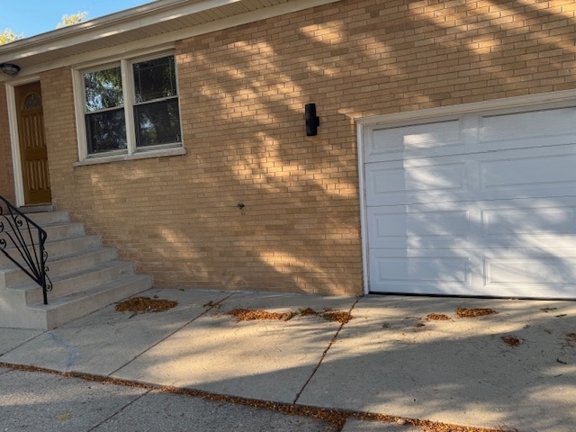 doorway to property with a garage