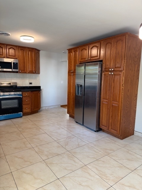 kitchen featuring stainless steel appliances and backsplash