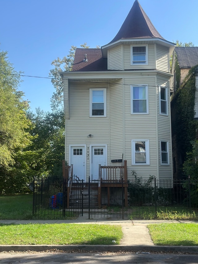 rear view of house with a garage and a yard