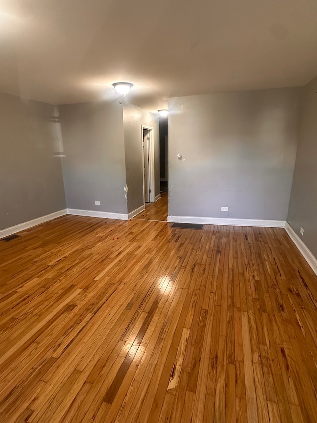 empty room with light hardwood / wood-style flooring