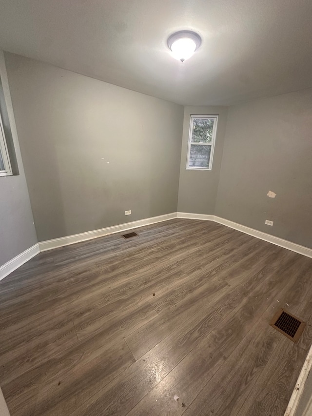 unfurnished room with dark hardwood / wood-style floors