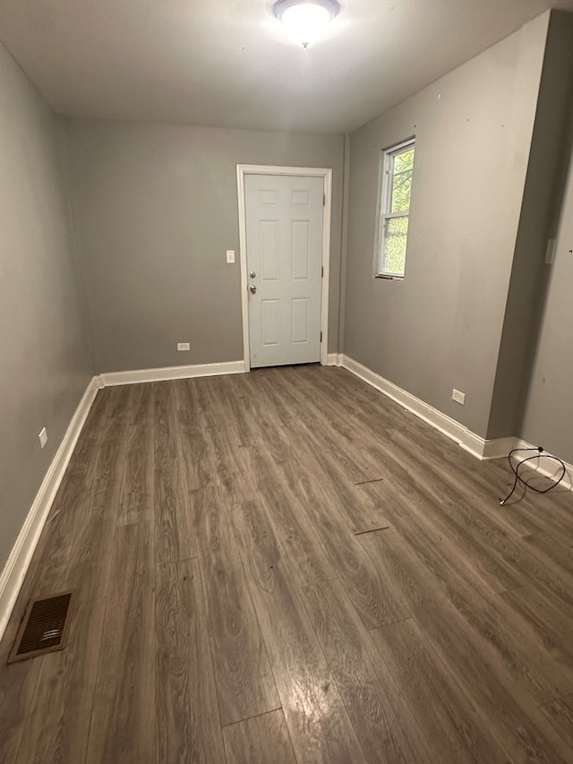 unfurnished room featuring dark wood-type flooring