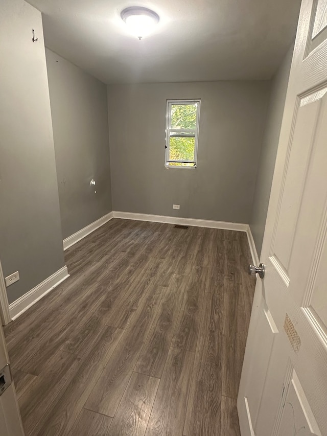 empty room with dark hardwood / wood-style floors