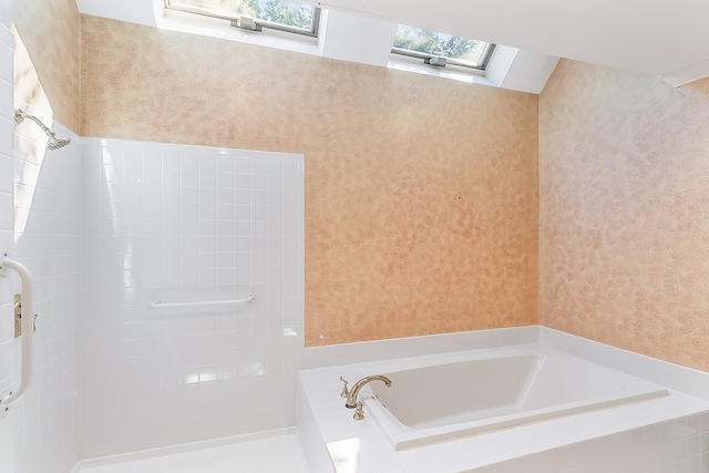 bathroom with a skylight and separate shower and tub