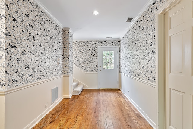 unfurnished room featuring crown molding and hardwood / wood-style floors