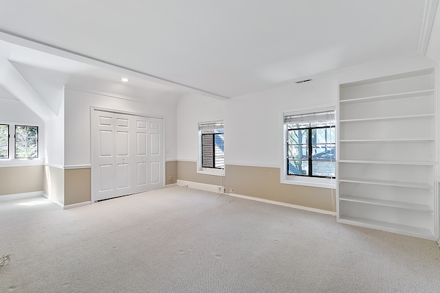 unfurnished bedroom featuring light carpet and a closet