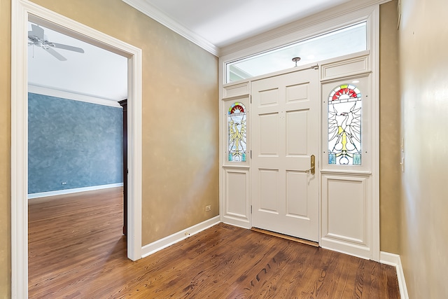 foyer entrance with ceiling fan, ornamental molding, and dark wood-type flooring