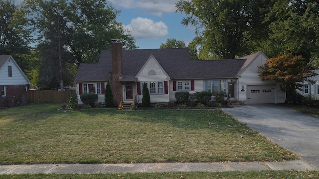 view of front of house with a front yard and a garage