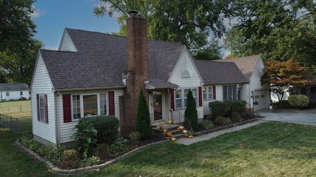 view of front of home with a garage and a front lawn