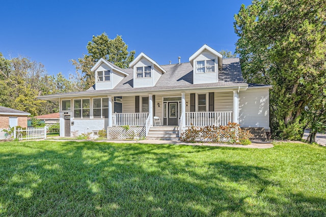 new england style home featuring a porch and a front lawn