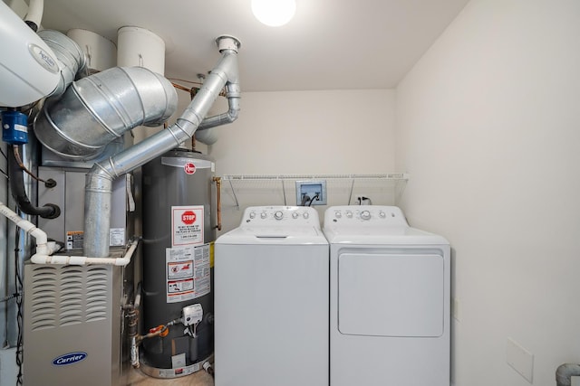 washroom featuring laundry area, gas water heater, and washer and dryer