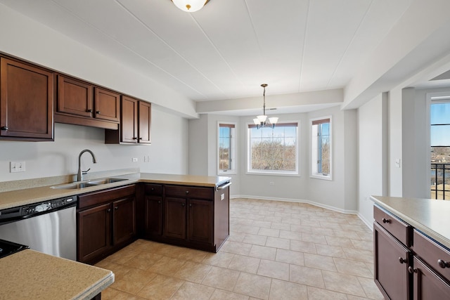 kitchen featuring dishwasher, light countertops, a healthy amount of sunlight, and a sink