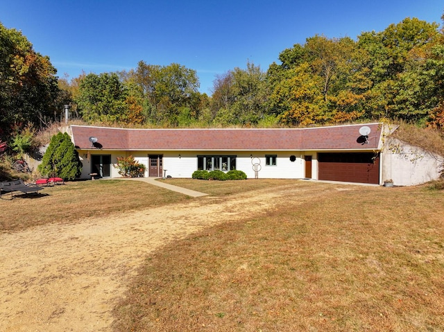 ranch-style house featuring a garage, driveway, and a front lawn