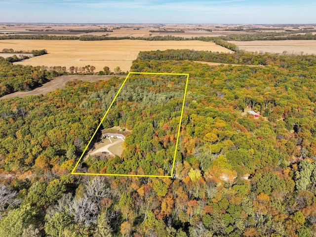 birds eye view of property featuring a wooded view