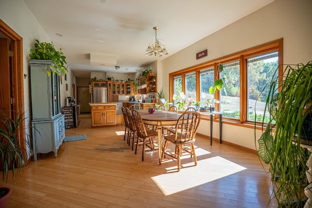 802 Union Rd, Harmon, IL 61042 - dining space featuring a chandelier, light wood-type flooring, and baseboards