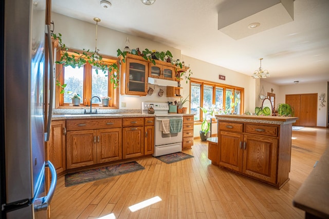 802 Union Rd, Harmon, IL 61042 - kitchen with electric range, freestanding refrigerator, a sink, and brown cabinets