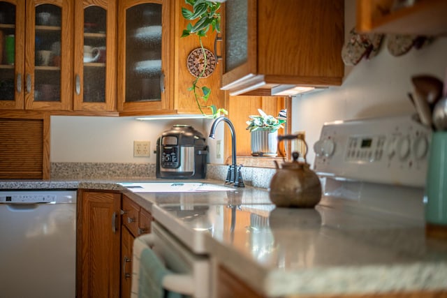802 Union Rd, Harmon, IL 61042 - kitchen with dishwasher, brown cabinetry, glass insert cabinets, and light countertops