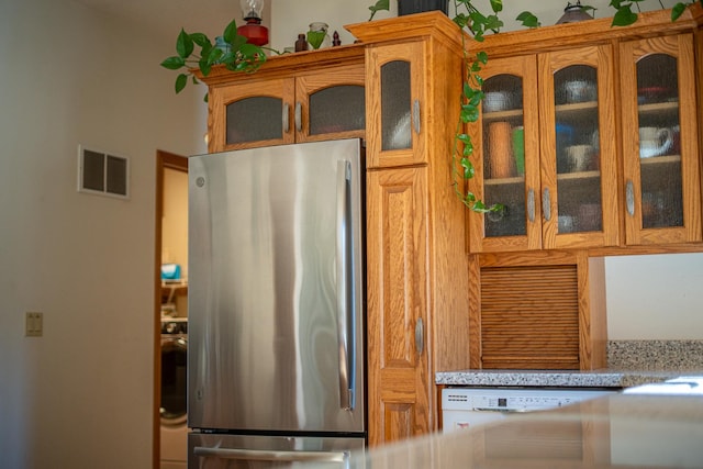 802 Union Rd, Harmon, IL 61042 - kitchen with freestanding refrigerator, glass insert cabinets, white dishwasher, and brown cabinetry