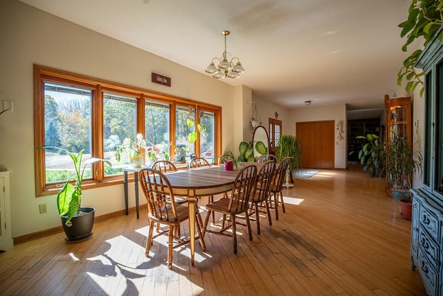 802 Union Rd, Harmon, IL 61042 - dining space featuring a chandelier, light wood-style floors, and baseboards