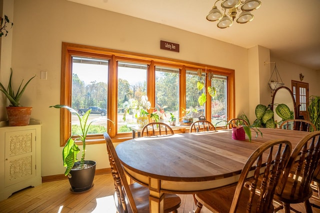 802 Union Rd, Harmon, IL 61042 - dining area with a chandelier, wood-type flooring, healthy amount of natural light, and baseboards